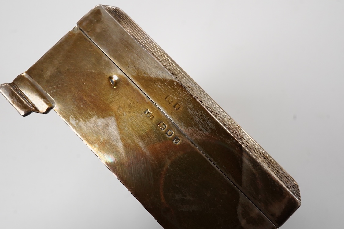 An Elizabeth II engine turned silver and yellow metal square compact, by Mappin & Webb, Birmingham, 1953, 69mm, together with a George V silver concave card case, Birmingham, 1911.